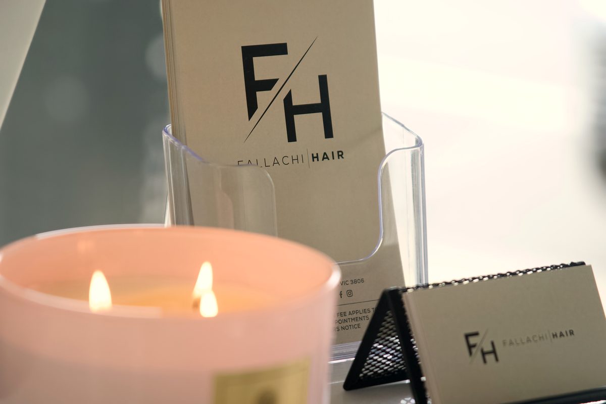 Fallachi Hair cards beside a candle at reception