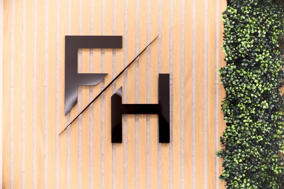 The Fallachi Hair monogram on the timber feature wall