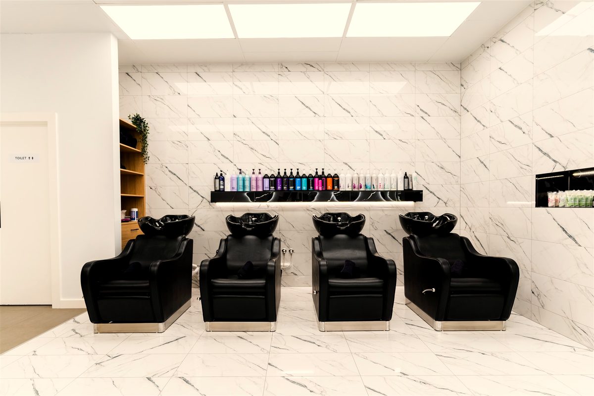 Marble wash-basin area with professional haircare at Fallachi Hair