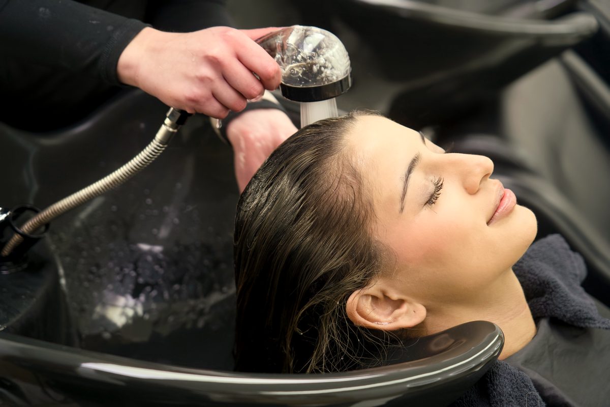 A client relaxing at the basin during a wash at Fallachi Hair